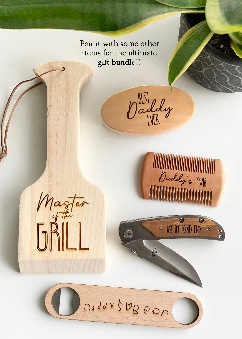 Custom wooden barbecue scraper, wooden comb, engraved pocket knife, and bottle opener with personalized handwriting designs on white surface