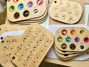Natural wooden alphabet and number puzzle inserts with colored circles for Flisat bins on white surface