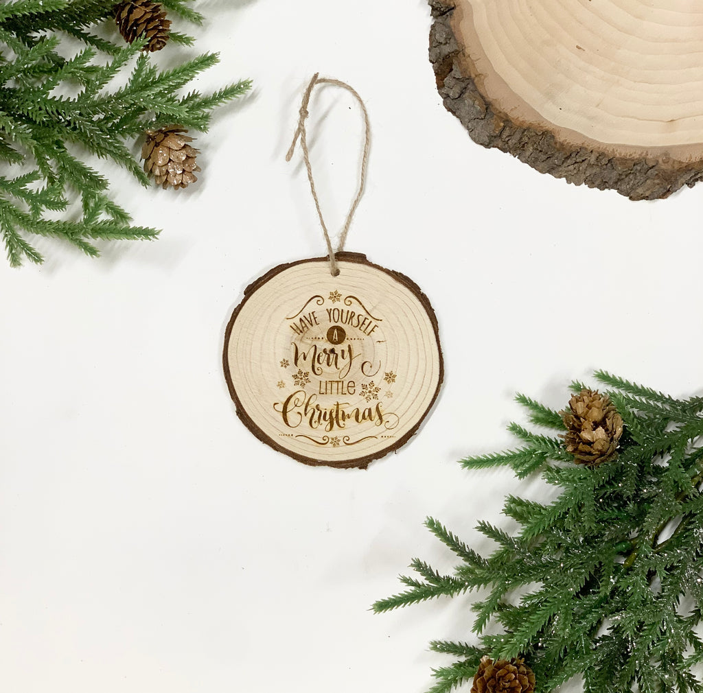 Round wood slice Christmas ornament with burnt script "Have yourself a merry little Christmas" and attached twine hanger
