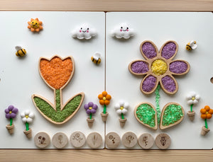 Wooden sensory tray with tulip and daisy-shaped compartments filled with colorful textured sensory beads on white background