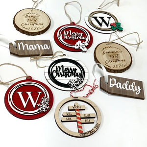 Assorted personalized wooden Christmas ornaments with names and holiday greetings on white background