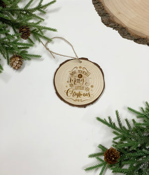 Round wood slice Christmas ornament with natural bark edge and engraved "Have yourself a merry little Christmas" text