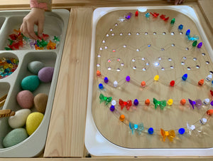 Light Up Easter Egg Flisat insert with colorful light pegs and felt eggs beside storage tray on wooden table