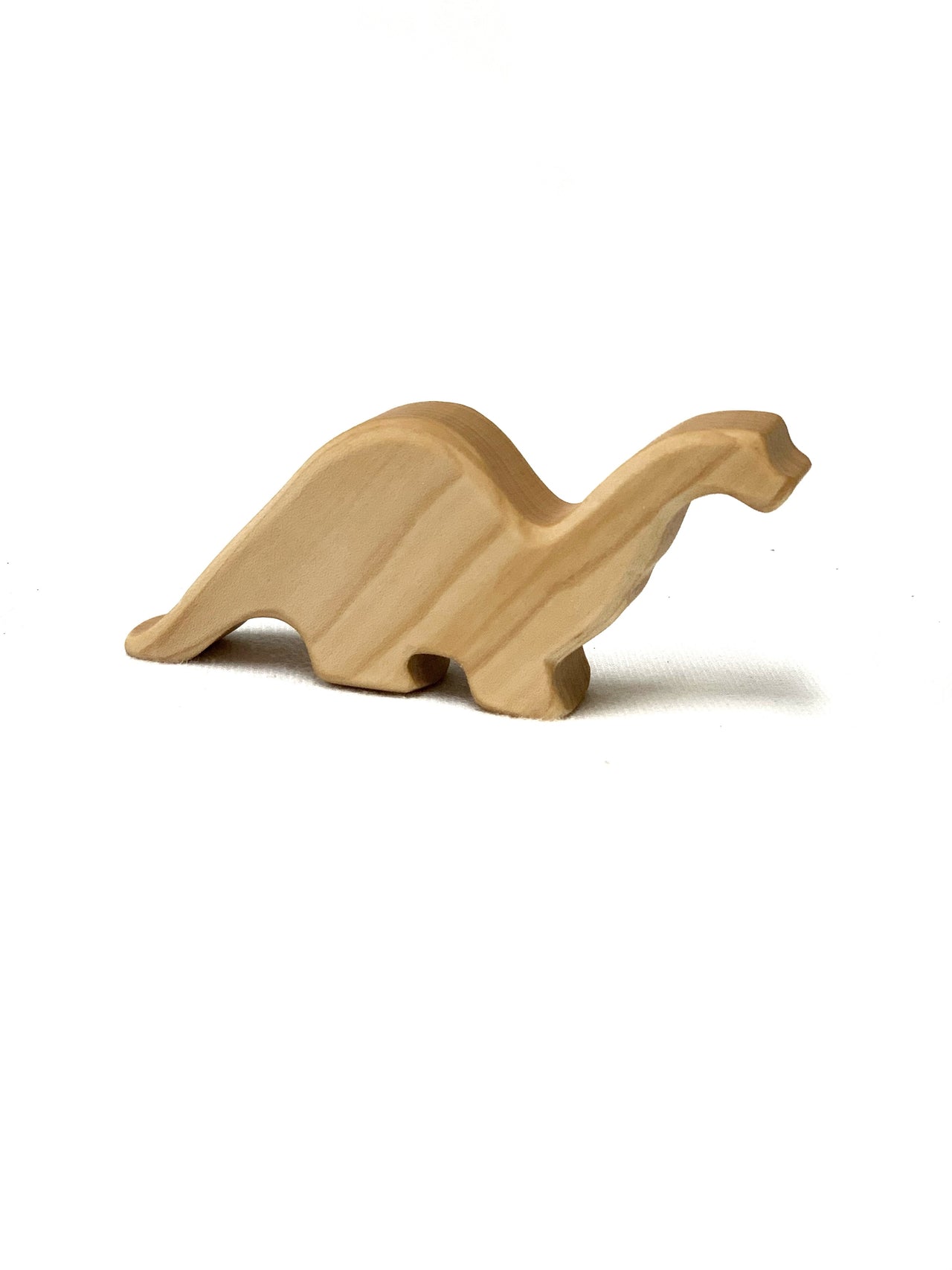 Small natural wooden baby long neck Brachiosaurus toy figurine on white background