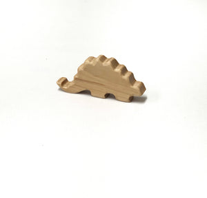 Small natural wooden dinosaur toy figurine with smooth edges on white background for imaginative play