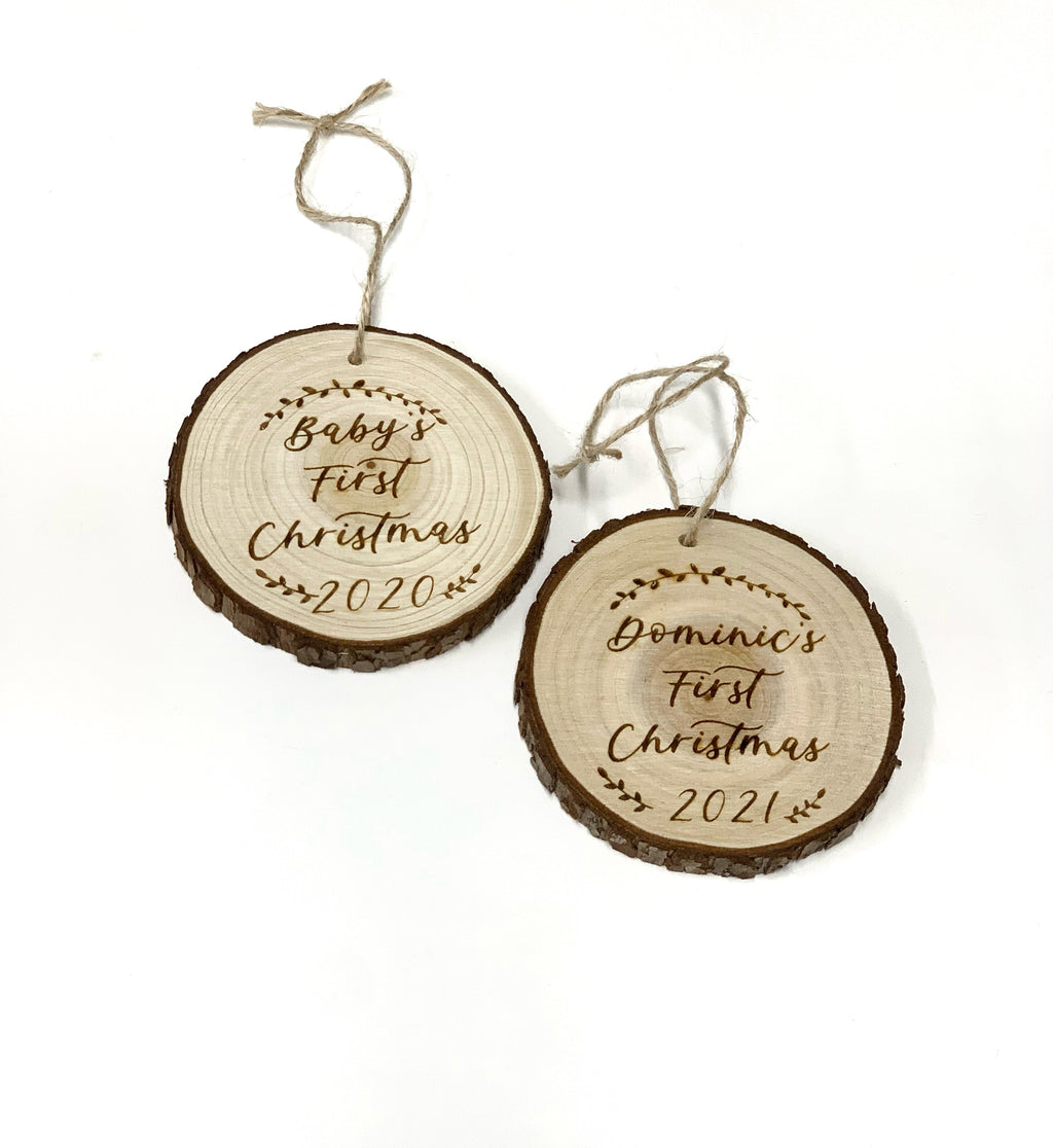 Two wood burned round Christmas ornaments with natural bark edges engraved with baby's first Christmas and years 2020 and 2021