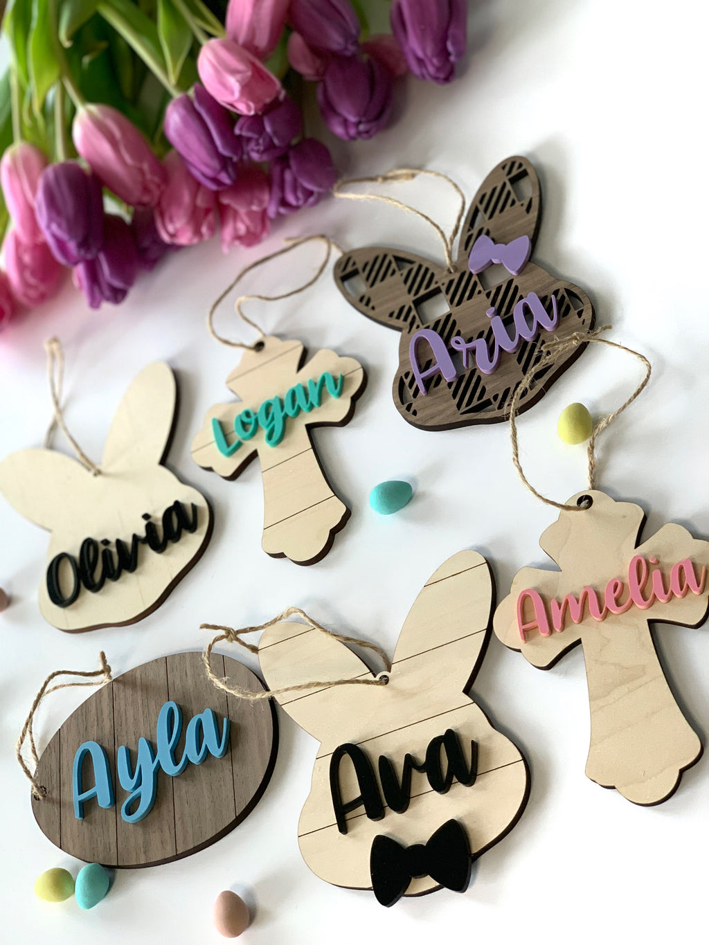 Custom wooden Easter basket name tags in bunny and cross shapes with colorful acrylic names and string hangers