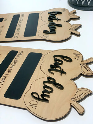 Reversible wooden first and last day of school sign with chalkboard sections and black cursive lettering on natural wood background
