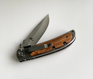Folded custom wooden pocket knife with stainless steel blade and natural wood handle on white background