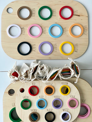 Natural wooden Flisat table bin lid with colorful painted rings and matching color names engraved around holes