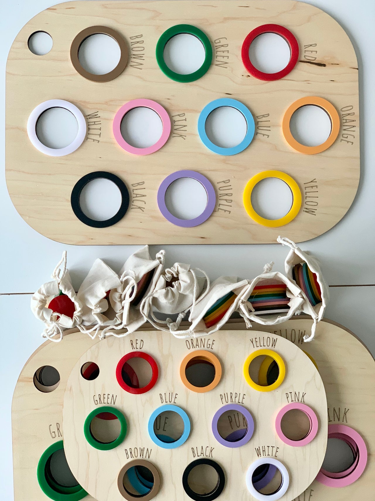 Natural wooden Flisat table bin lid with colorful painted rings and matching color names engraved around holes