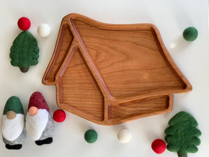 Whimsical 3D wooden house-shaped sensory tray with smooth natural wood grain surrounded by felt gnomes and trees decorations