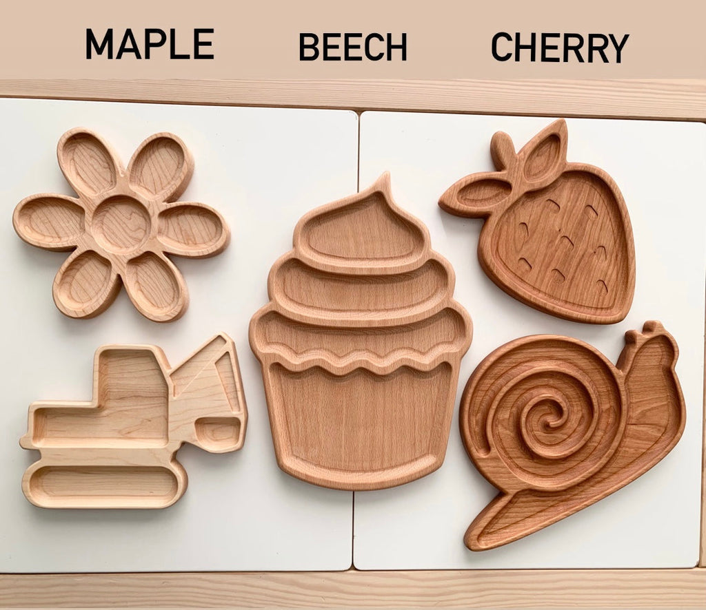 Three sets of wooden sensory trays shaped like flower, cupcake, strawberry, excavator, and snail in maple, beech, and cherry wood finishes