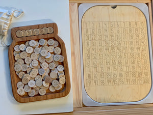 Maple wood 100 hundred frame board with numbered wooden discs next to clear dry erase acrylic insert in wooden tray