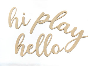 Unfinished custom word cutouts spelling hi play hello in cursive script on white background