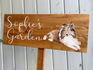 Large custom wooden garden sign with white cursive letters and painted dog illustration on natural wood background