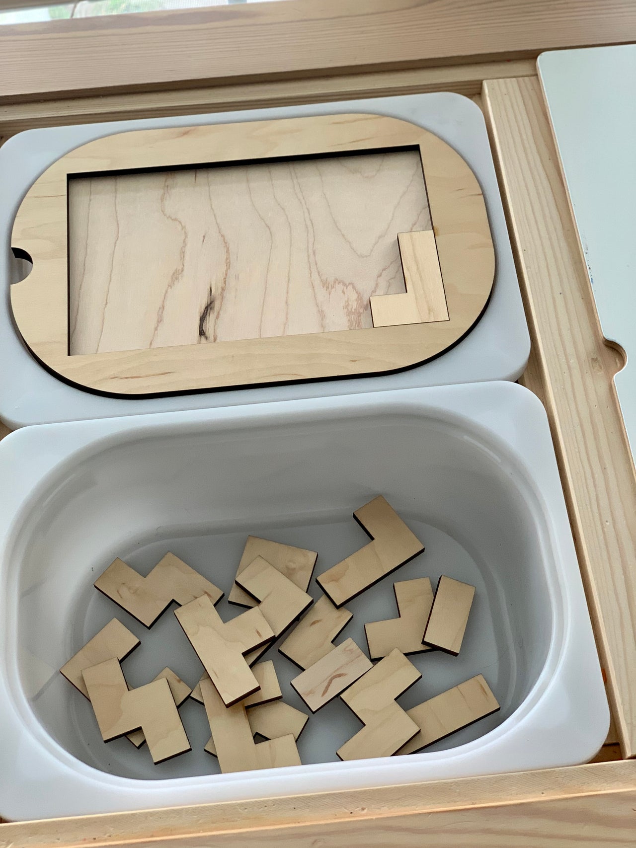 Small wooden puzzle Flisat table top insert with natural wood pieces inside white plastic bin tray