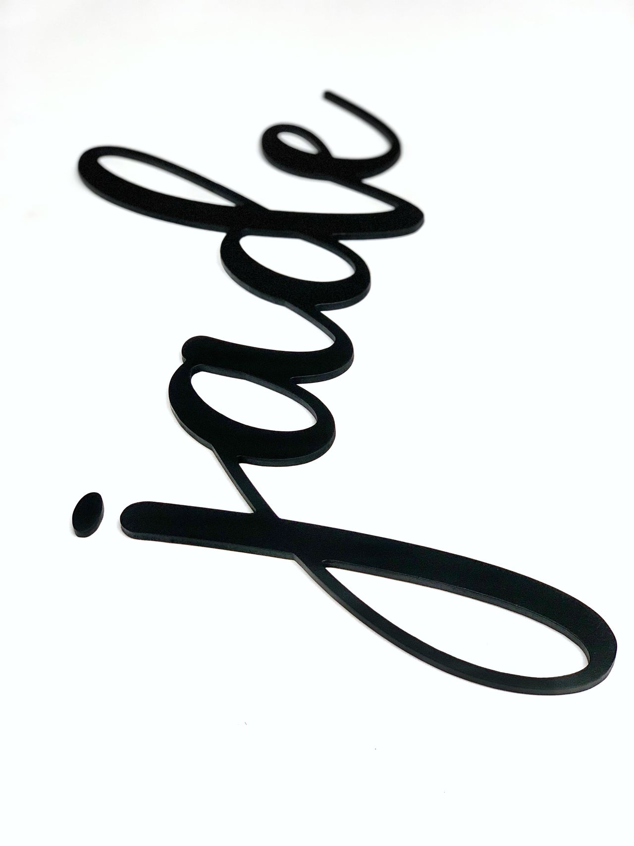 Black custom word cutout in cursive script spelling "jade" on white background with smooth edges