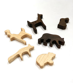 Natural wooden woodland animal toy figurines in light and dark wood tones on white background
