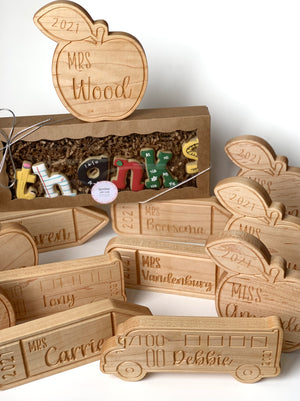 Personalized wooden teacher name plates shaped like apples and school buses with engraved names and year 2021