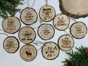 Set of round wood burned Christmas ornaments with various festive sayings and natural bark edges on white background