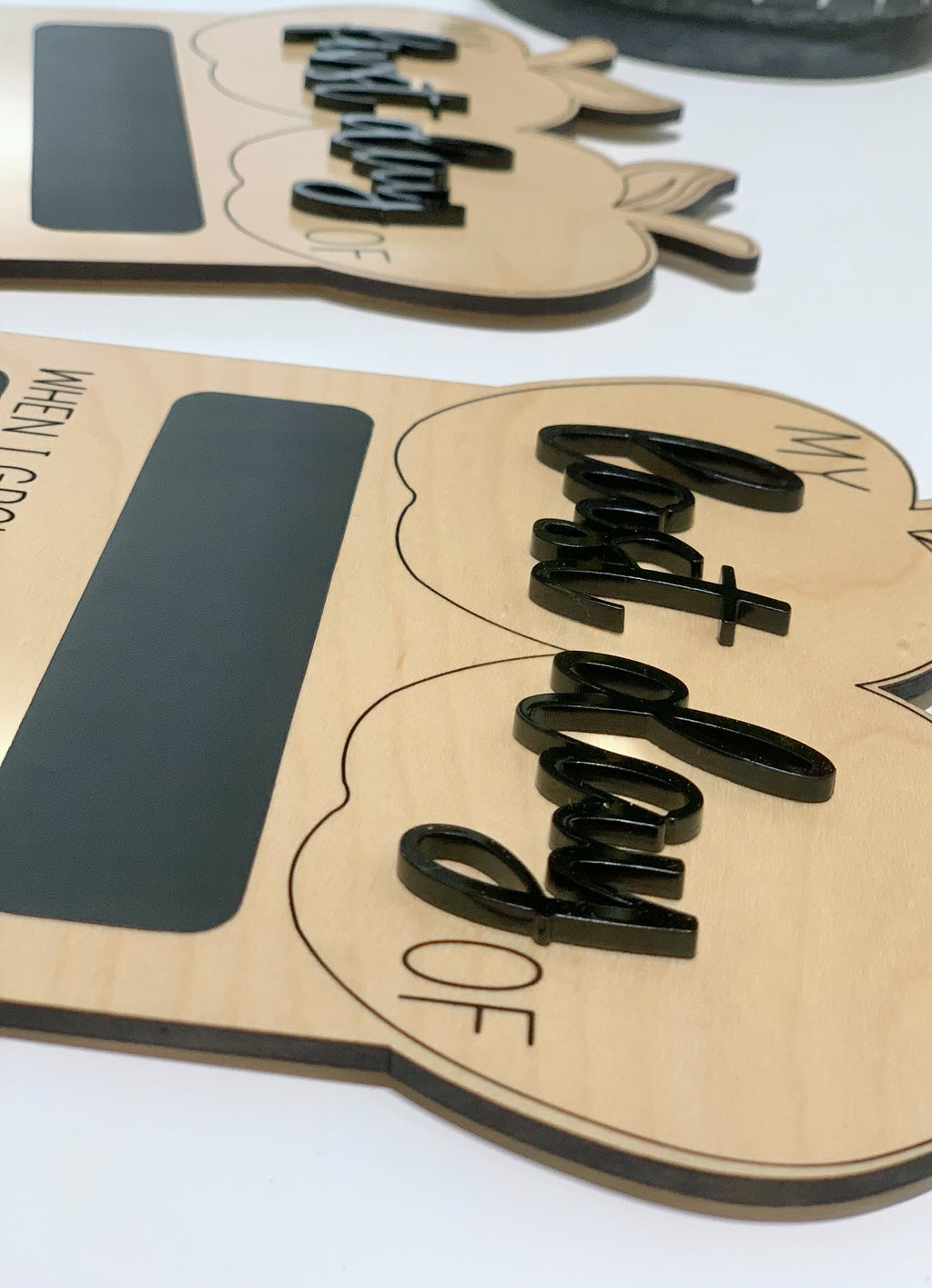 Reversible wooden first and last day of school sign with black chalkboard and raised black cursive lettering on light wood background