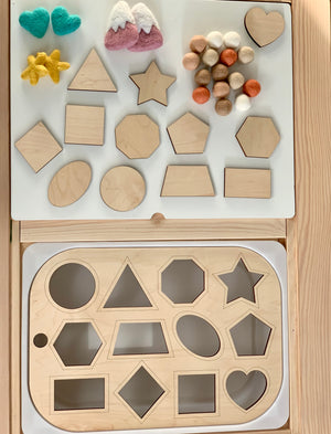 Wooden shape sorter Flisat table top insert with geometric shapes and colorful felt balls on wooden surface